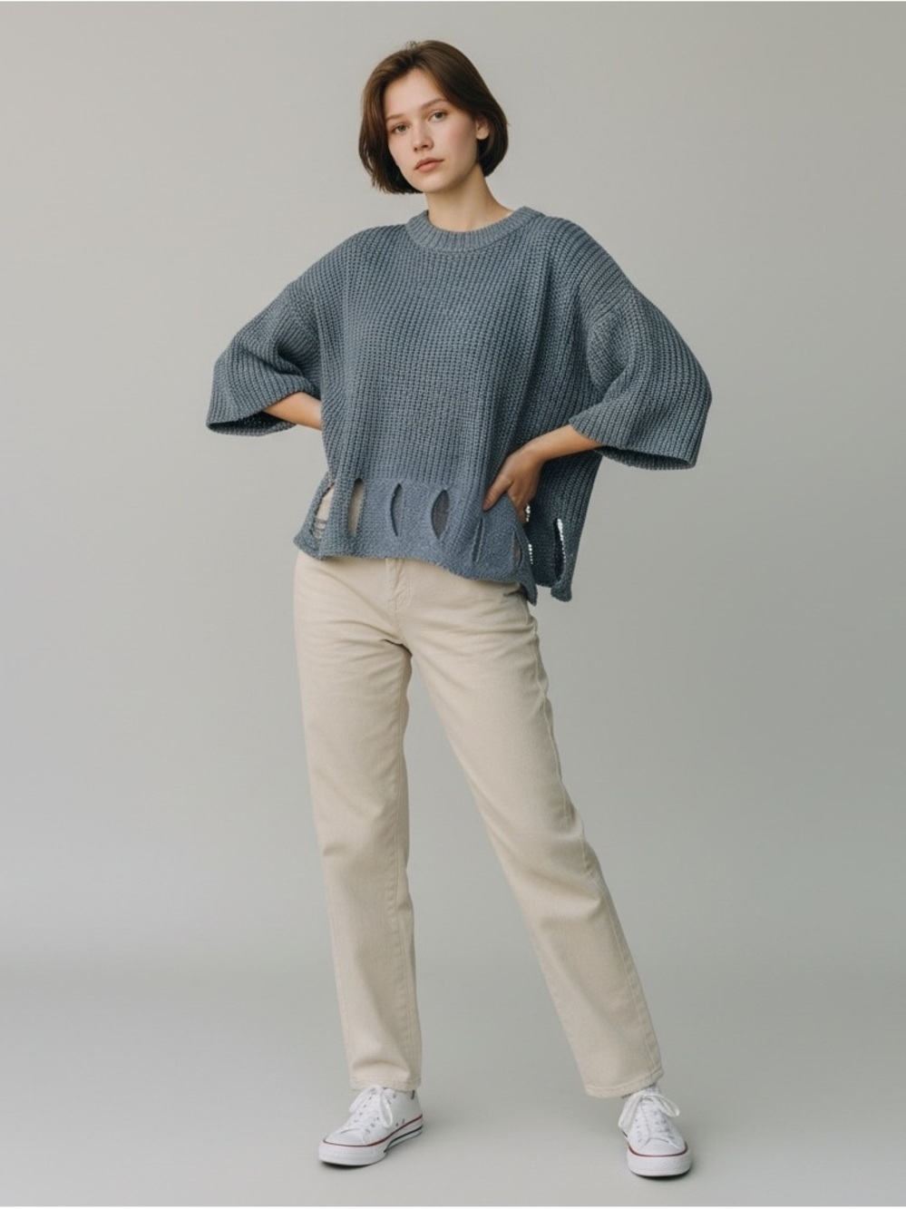 This garment is a distressed cut-out knit top